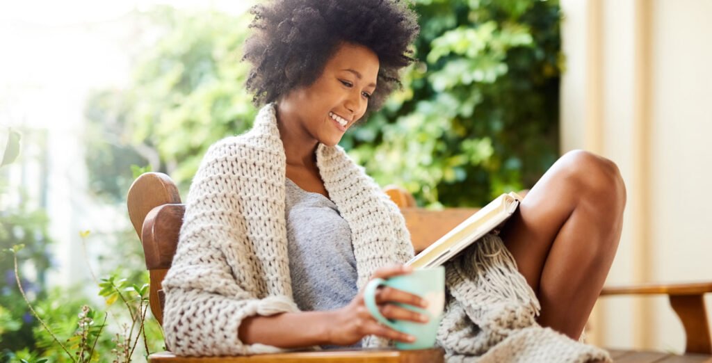 woman drinking coffee and reading a book - home brewing coffee - go joe bean