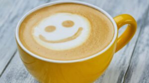 coffee with a smiling face in the foam - coffee benefits - gojoebean