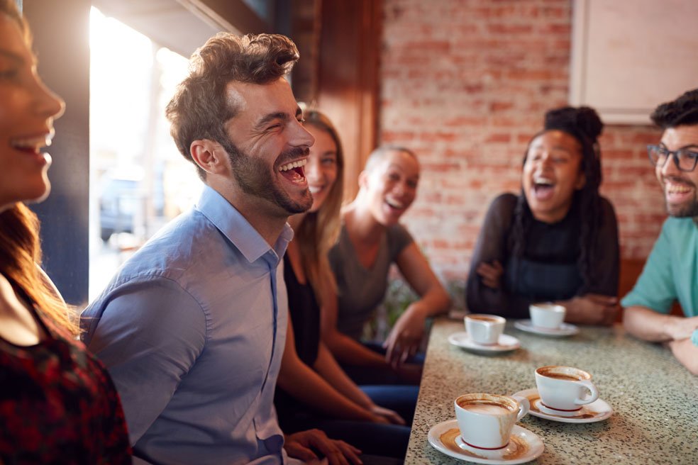 group of happy friends drinking coffee - coffee benefits - go joe bean